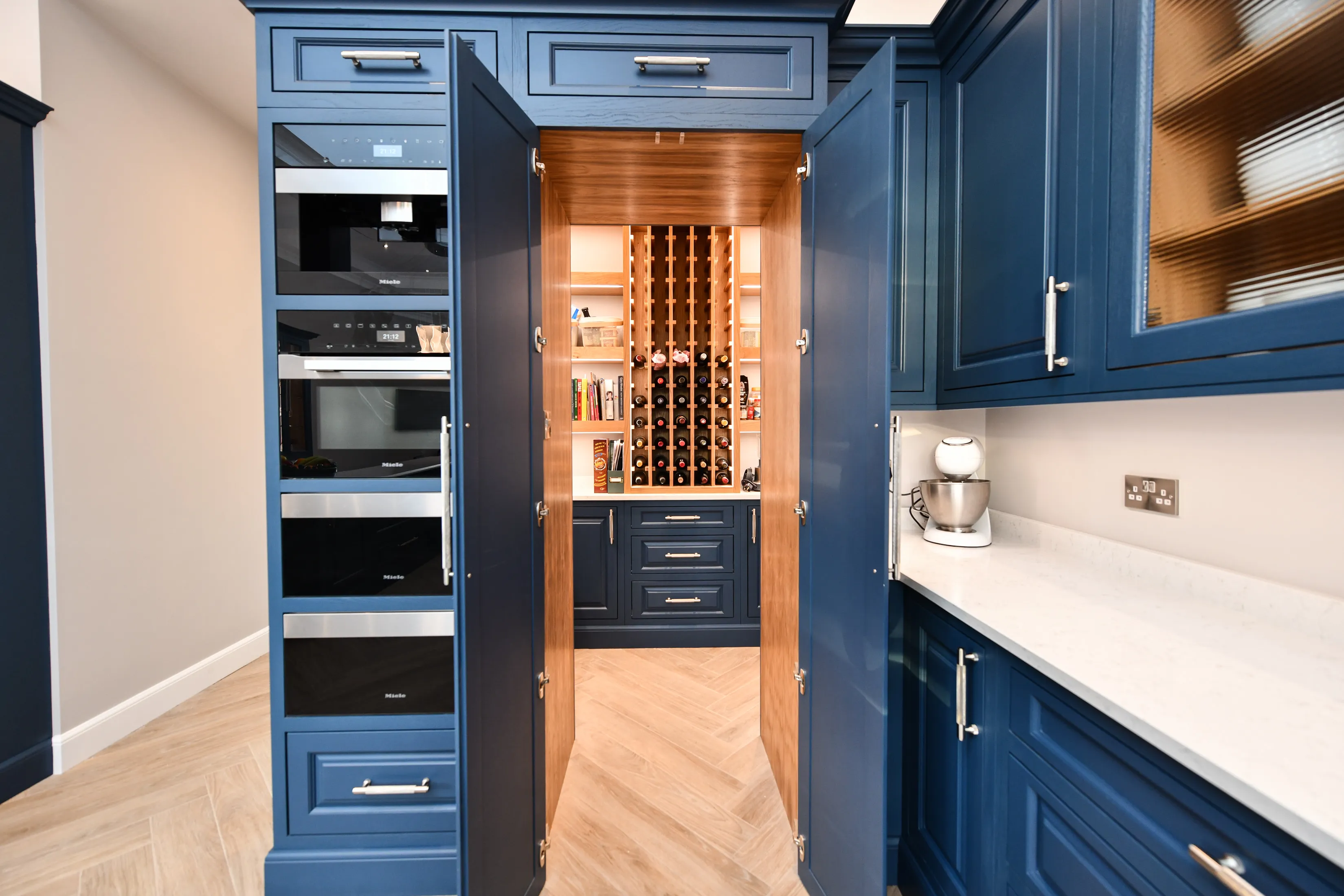 Large kitchen with bespoke pantry featuring lots of storage and a custom made wine rack